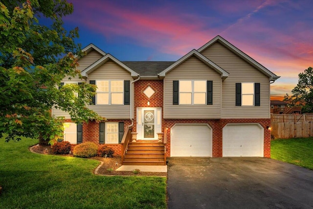 590 Keystone Dr NW, Christiansburg, VA 24073 - split foyer home featuring asphalt driveway, an attached garage, and brick siding