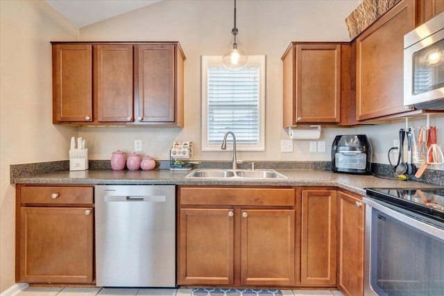 590 Keystone Dr NW, Christiansburg, VA 24073 - kitchen with stainless steel appliances, a sink, dark countertops, brown cabinets, and lofted ceiling