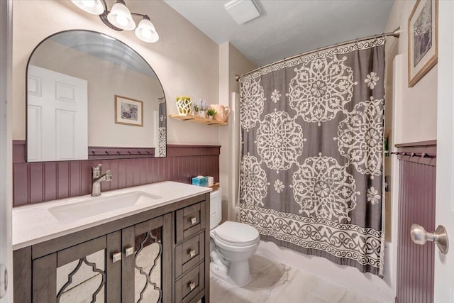 590 Keystone Dr NW, Christiansburg, VA 24073 - full bath featuring marble look tile flooring, vanity, shower / bath combination with curtain, a wainscoted wall, and toilet