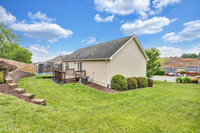 590 Keystone Dr NW, Christiansburg, VA 24073 - back of property with a trampoline, a deck, central AC, and roof with shingles