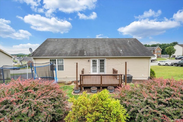 590 Keystone Dr NW, Christiansburg, VA 24073 - rear view of house with a trampoline, a wooden deck, french doors, and a yard