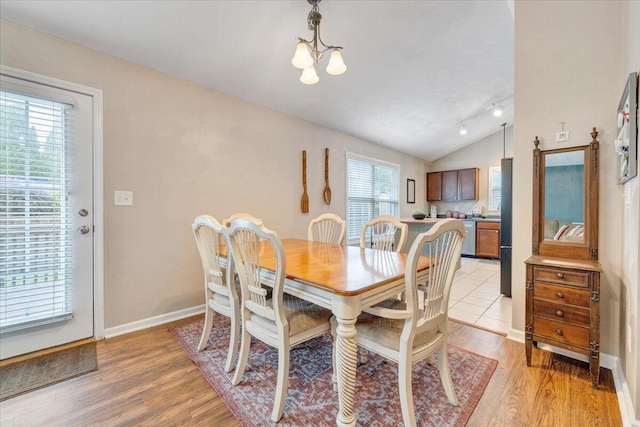 590 Keystone Dr NW, Christiansburg, VA 24073 - dining area featuring a chandelier, light wood-style flooring, vaulted ceiling, and baseboards