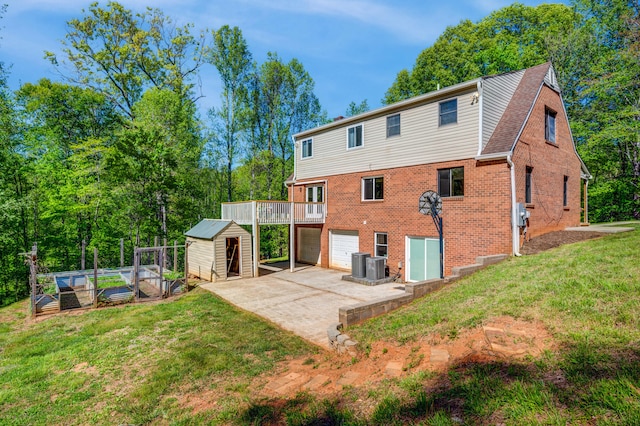 1132 Bancroft Ln, Goode, VA 24556 - back of house featuring a garage, brick siding, a yard, a garden, and driveway