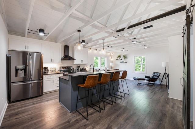 1132 Bancroft Ln, Goode, VA 24556 - kitchen with appliances with stainless steel finishes, wall chimney range hood, dark countertops, white cabinets, and an island with sink
