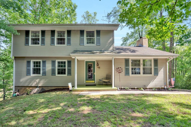 508 Hemlock Shores Dr, Goodview, VA 24095 - view of front facade featuring a porch, a front yard, and a chimney