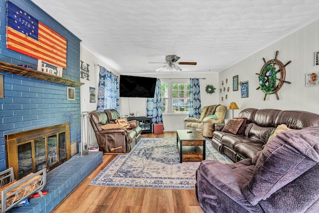 508 Hemlock Shores Dr, Goodview, VA 24095 - living area featuring a ceiling fan, wood finished floors, a fireplace, and crown molding