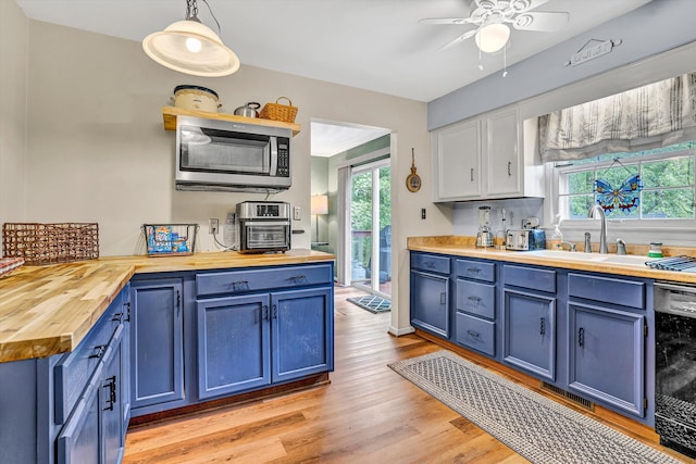 508 Hemlock Shores Dr, Goodview, VA 24095 - kitchen featuring butcher block countertops, blue cabinetry, stainless steel microwave, dishwasher, and healthy amount of natural light