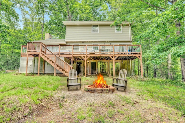 508 Hemlock Shores Dr, Goodview, VA 24095 - rear view of house featuring a fire pit, a wooden deck, stairway, and a chimney