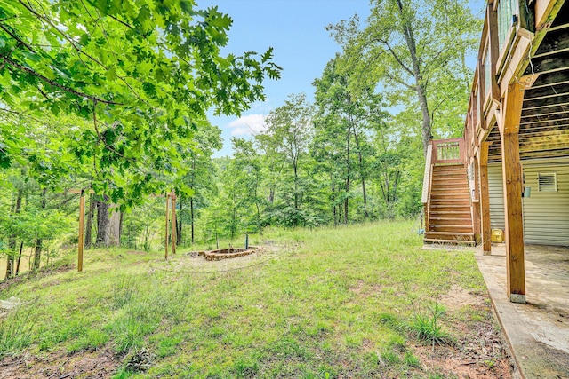 508 Hemlock Shores Dr, Goodview, VA 24095 - view of yard featuring stairway, a wooden deck, and a fire pit