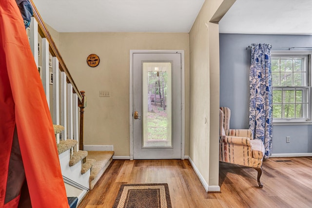 508 Hemlock Shores Dr, Goodview, VA 24095 - foyer entrance with wood finished floors, stairway, and baseboards