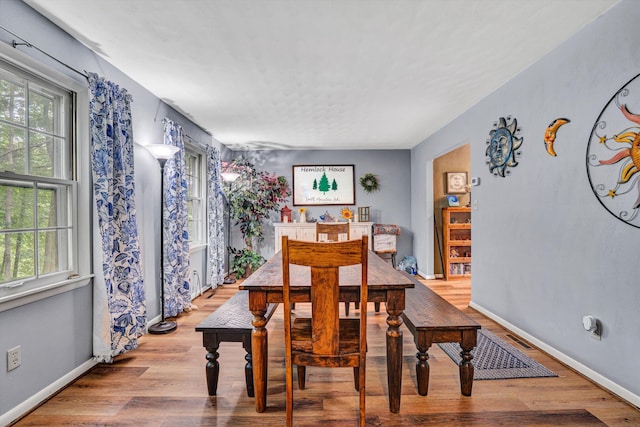 508 Hemlock Shores Dr, Goodview, VA 24095 - dining room featuring healthy amount of natural light, wood finished floors, and baseboards