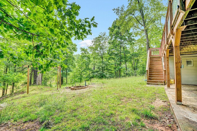 508 Hemlock Shores Dr, Goodview, VA 24095 - view of yard featuring stairway, a wooden deck, and a fire pit