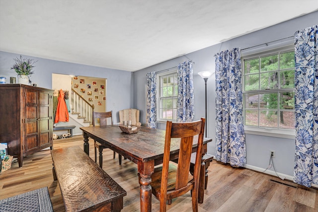 508 Hemlock Shores Dr, Goodview, VA 24095 - dining space featuring stairway, light wood-style flooring, and baseboards