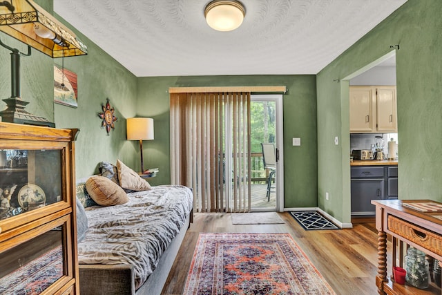 508 Hemlock Shores Dr, Goodview, VA 24095 - bedroom featuring access to exterior, wood finished floors, and baseboards