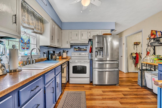 508 Hemlock Shores Dr, Goodview, VA 24095 - kitchen with stainless steel fridge, white electric range, a sink, blue cabinetry, and ceiling fan