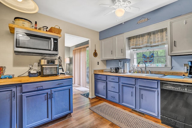 508 Hemlock Shores Dr, Goodview, VA 24095 - kitchen featuring black dishwasher, stainless steel microwave, blue cabinets, wooden counters, and wood finished floors