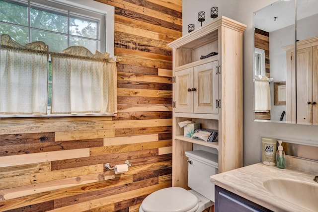 508 Hemlock Shores Dr, Goodview, VA 24095 - bathroom featuring wooden walls, vanity, and toilet
