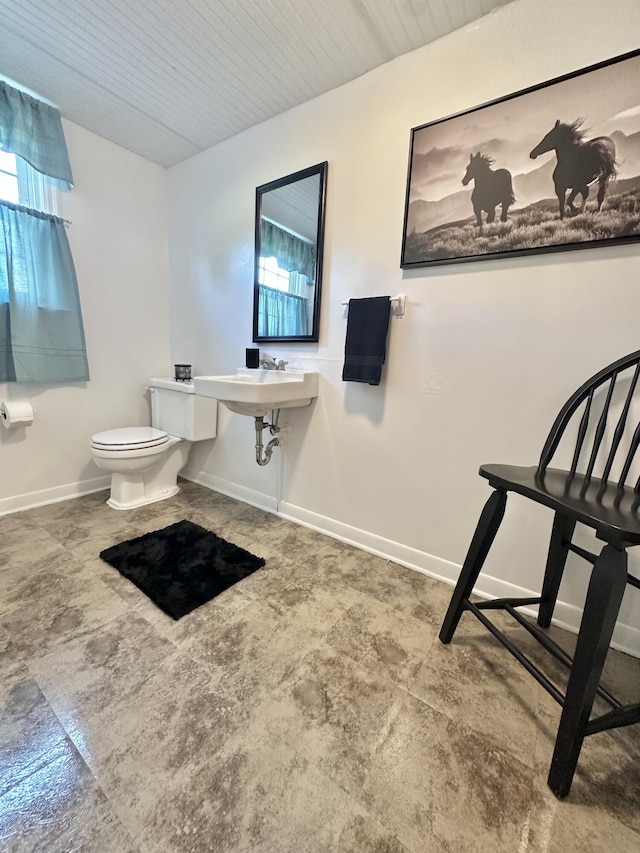 104 Wintergreen Ave, Clifton Forge, VA 24422 - bathroom with toilet, plenty of natural light, a sink, and baseboards