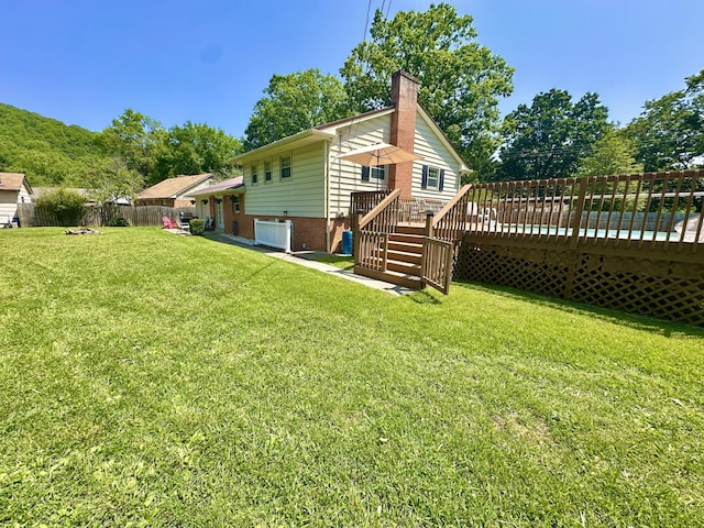 104 Wintergreen Ave, Clifton Forge, VA 24422 - back of property featuring a deck, a chimney, and brick siding