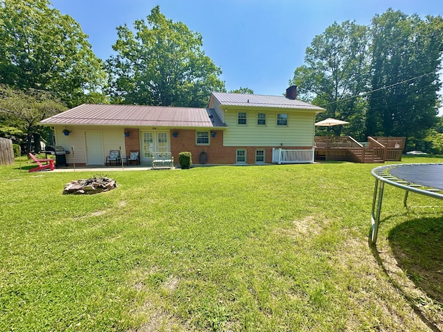 104 Wintergreen Ave, Clifton Forge, VA 24422 - back of house with a trampoline, french doors, a wooden deck, a chimney, and brick siding