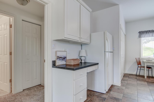 1103 Mariners Way Unit 5, Huddleston, VA 24104 - kitchen with freestanding refrigerator, dark countertops, white cabinetry, and baseboards