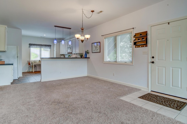 1103 Mariners Way Unit 5, Huddleston, VA 24104 - kitchen featuring light colored carpet, a chandelier, light tile patterned floors, dark countertops, and white appliances