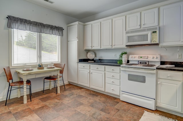 1103 Mariners Way Unit 5, Huddleston, VA 24104 - kitchen featuring white appliances, dark countertops, light stone finish flooring, white cabinets, and baseboards