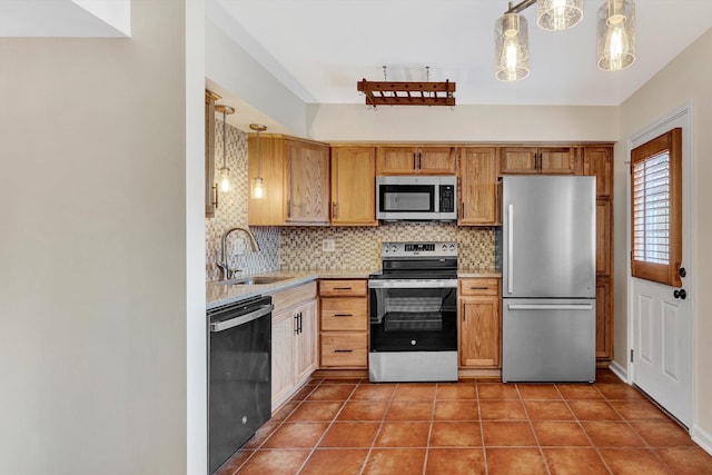 1801 Bluemont Ave SW Unit G, Roanoke, VA 24015 - kitchen featuring appliances with stainless steel finishes, a sink, light countertops, tasteful backsplash, and hanging light fixtures