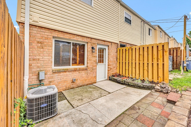 1801 Bluemont Ave SW Unit G, Roanoke, VA 24015 - back of property featuring cooling unit, brick siding, and a patio area