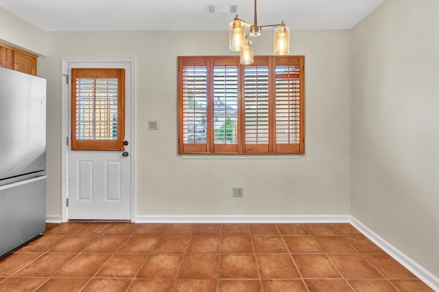 1801 Bluemont Ave SW Unit G, Roanoke, VA 24015 - unfurnished dining area featuring baseboards, tile patterned flooring, and a chandelier