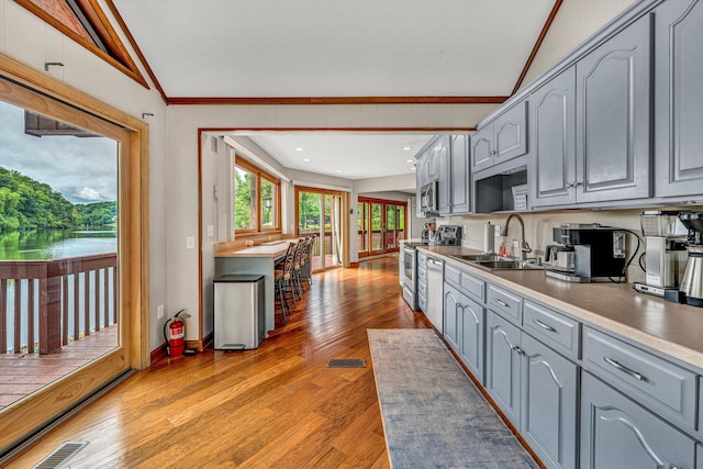 510 Crestview Rd, Wirtz, VA 24184 - kitchen with a sink, gray cabinets, appliances with stainless steel finishes, lofted ceiling, and light wood-style flooring