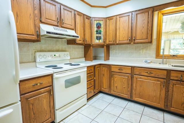 1978 Laurel Creek Rd NE, Pilot, VA 24138 - kitchen with white appliances, under cabinet range hood, brown cabinets, backsplash, and crown molding