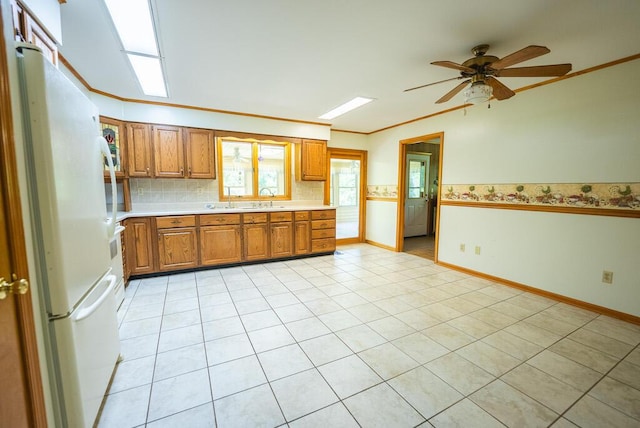 1978 Laurel Creek Rd NE, Pilot, VA 24138 - kitchen with freestanding refrigerator, brown cabinetry, light countertops, a ceiling fan, and a sink