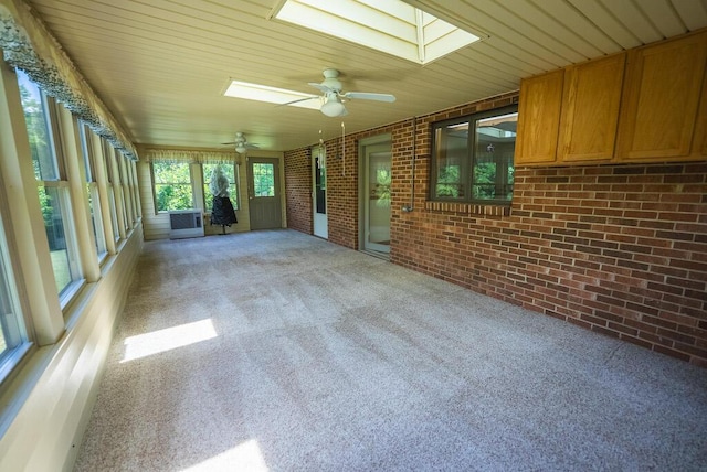 1978 Laurel Creek Rd NE, Pilot, VA 24138 - unfurnished sunroom featuring brick wall, a skylight, ceiling fan, carpet flooring, and wood ceiling