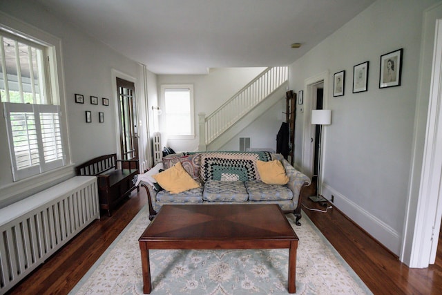 1810 Windsor Ave SW, Roanoke, VA 24015 - living area with radiator heating unit, dark wood-style flooring, stairs, and baseboards