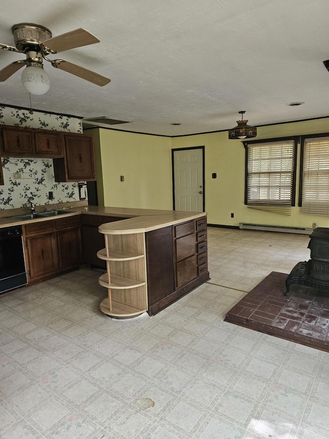 145 Carlos Rd, Union Hall, VA 24176 - kitchen featuring a wood stove, dishwasher, open shelves, a peninsula, and dark brown cabinetry