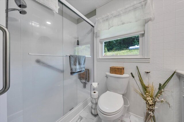 3135 Doe Run Rd, Rocky Mount, VA 24151 - bathroom featuring marble look tiles, toilet, and a stall shower