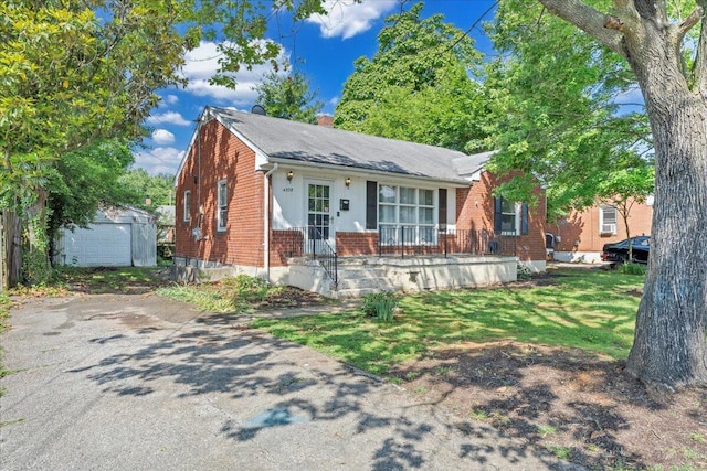 4708 Pawling St NW, Roanoke, VA 24012 - bungalow with brick siding, an outbuilding, a chimney, and roof with shingles
