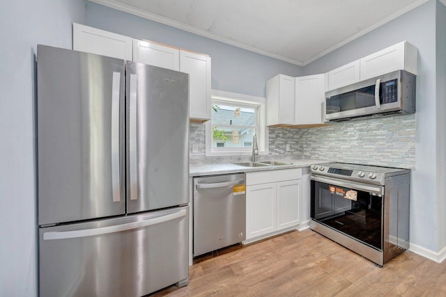 3311 Memorial Ave, Lynchburg, VA 24501 - kitchen with stainless steel appliances, white cabinetry, crown molding, and decorative backsplash