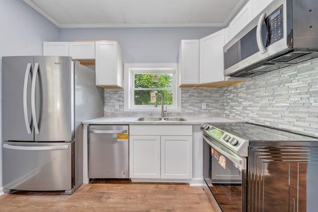 3311 Memorial Ave, Lynchburg, VA 24501 - kitchen with appliances with stainless steel finishes, crown molding, white cabinets, light countertops, and light wood-style floors