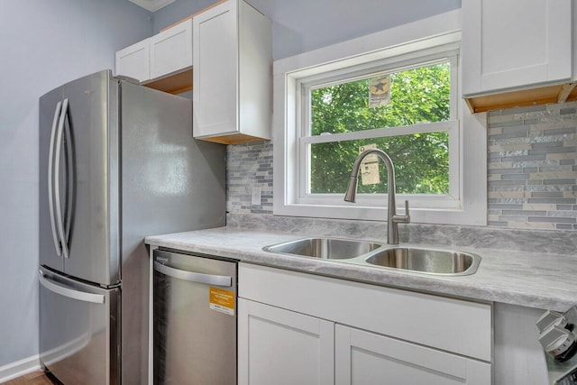 3311 Memorial Ave, Lynchburg, VA 24501 - kitchen featuring appliances with stainless steel finishes, white cabinetry, light countertops, and tasteful backsplash
