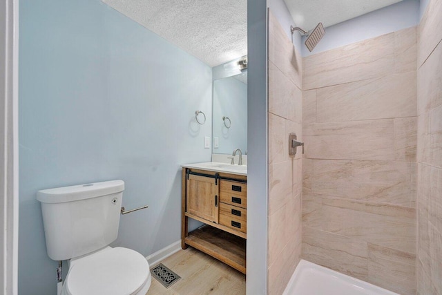 3311 Memorial Ave, Lynchburg, VA 24501 - full bath with vanity, wood finished floors, tiled shower, and a textured ceiling