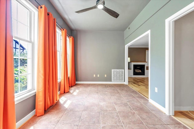 2208 Jefferson St SE Unit 104, Roanoke, VA 24014 - unfurnished room featuring ceiling fan, a fireplace, baseboards, and light tile patterned flooring