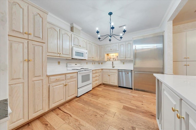 2208 Jefferson St SE Unit 104, Roanoke, VA 24014 - kitchen featuring appliances with stainless steel finishes, crown molding, light wood finished floors, a chandelier, and light countertops
