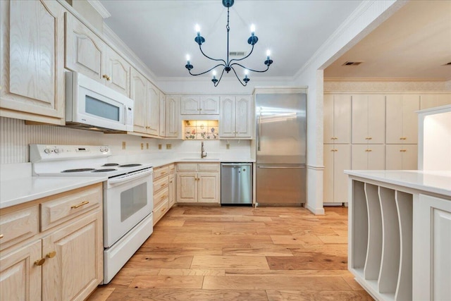 2208 Jefferson St SE Unit 104, Roanoke, VA 24014 - kitchen with stainless steel appliances, light wood finished floors, light countertops, a chandelier, and crown molding