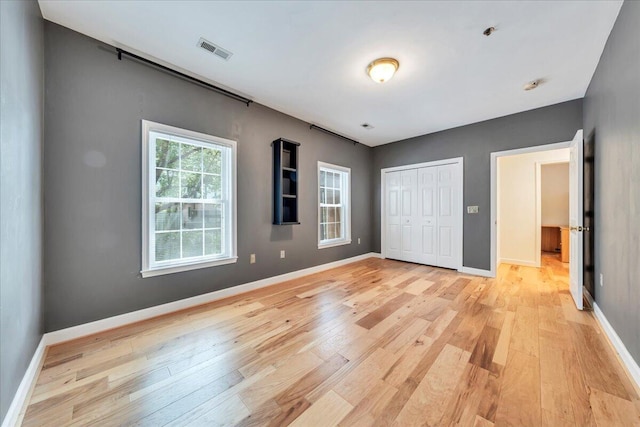 2208 Jefferson St SE Unit 104, Roanoke, VA 24014 - unfurnished bedroom featuring light wood-style floors, baseboards, and a closet