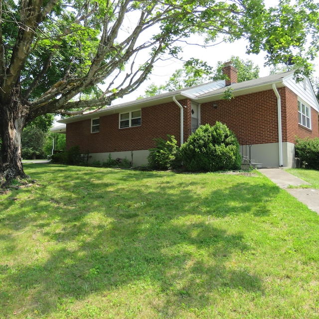383 Main St, New Castle, VA 24127 - view of home's exterior with brick siding, a chimney, and a lawn