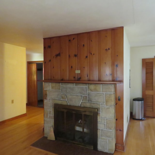 383 Main St, New Castle, VA 24127 - detailed view of wood finished floors, a stone fireplace, and baseboards