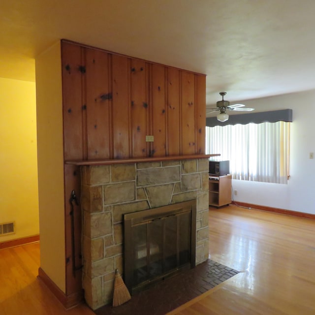 383 Main St, New Castle, VA 24127 - unfurnished living room featuring a fireplace, light wood-style flooring, baseboards, and a ceiling fan