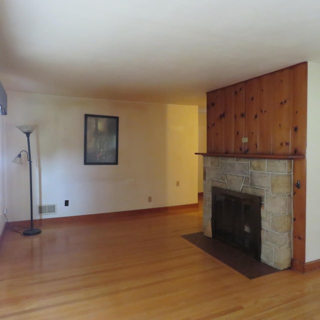 383 Main St, New Castle, VA 24127 - unfurnished living room with light wood-type flooring, a fireplace, and baseboards